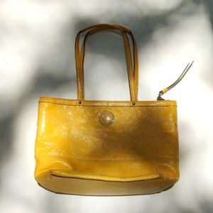Yellow leather Coach bag with some red rub off on backside